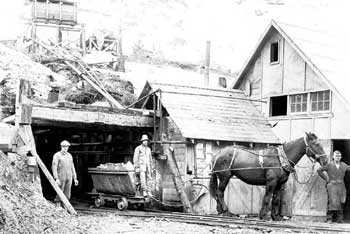 Cascade Tunnel construction showing men and horse pulling muck car, Berne, March 17, 1926