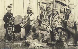 Chilkat Dancers in blankets with instruments. 1895