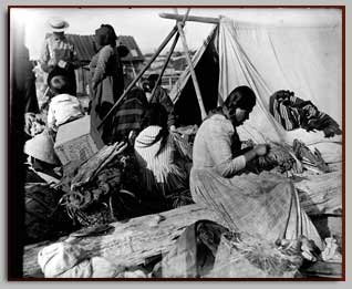 Makah Family Trading on beach at Port Townsend in 1899