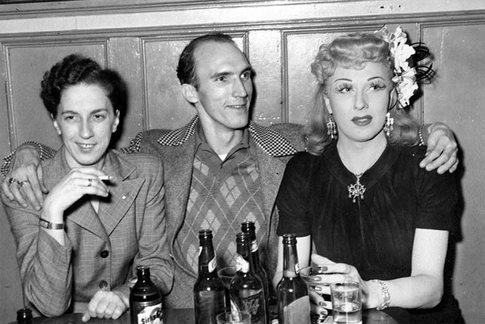 A blonde Jackie Starr with a man and a woman sitting at a table, probably Seattle, ca. 1946