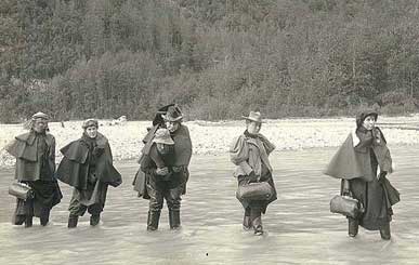 Actresses fording Dyea River on the Chilkoot Trail, Alaska, 1897