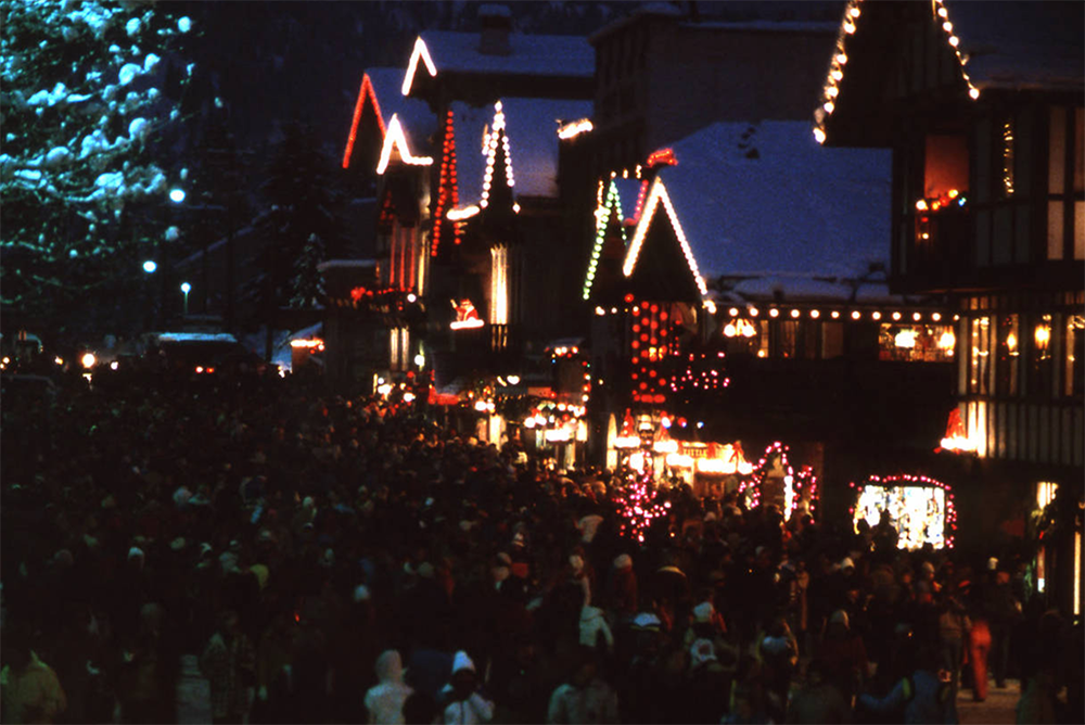 Lighted buildings with crowd mmingling in front of them