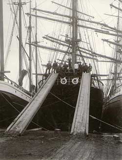 Loading lumber with chutes onto the deck of the sailing vessel, 1904
