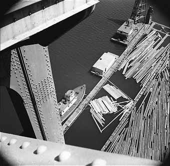 Log boom and boat under St. Johns Bridge, Portland, Oregon