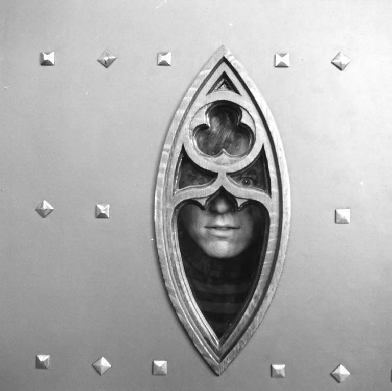 Seattle band the Daily Flash band member framed artistically by a decorative piece of architecture, Suzzallo Library