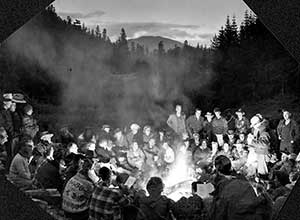 Sitting around campfire, 1951