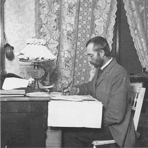 Alvin H. Waite seated at desk, 1892